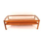 A teak oblong two tier coffee table, with plate gla