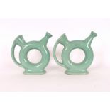 A pair of green glazed ewers, having impressed marks to bases, 23cm high