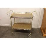 A 1970's gilt and Formica two tier tea trolley, wi