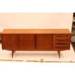 A Danish teak sideboard fitted four short drawers