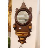 A decorative walnut and mahogany wall mirror, with