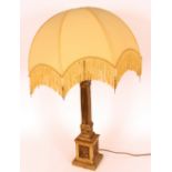 A brass Corinthian column table lamp with silk frin