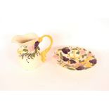 A brightly coloured jug and bowl set with floral a