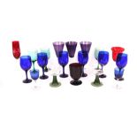 A collection of various coloured drinking glasses