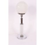 A chrome table lamp, with opaque white glass shade