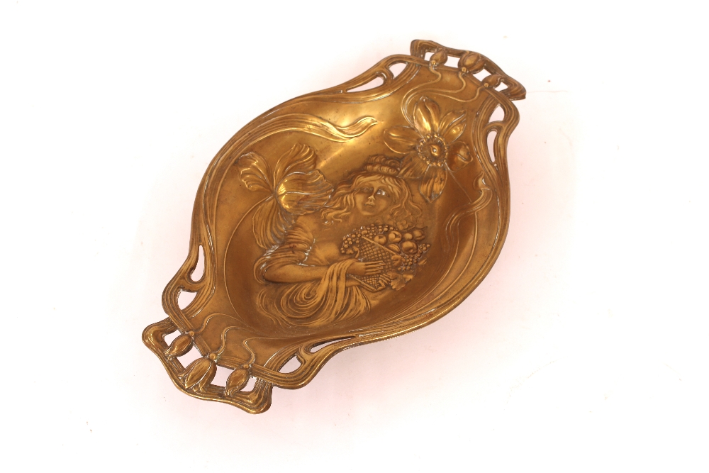 An Art Nouveau design brass fruit dish decorated w
