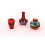 Three Poole pottery baluster vases