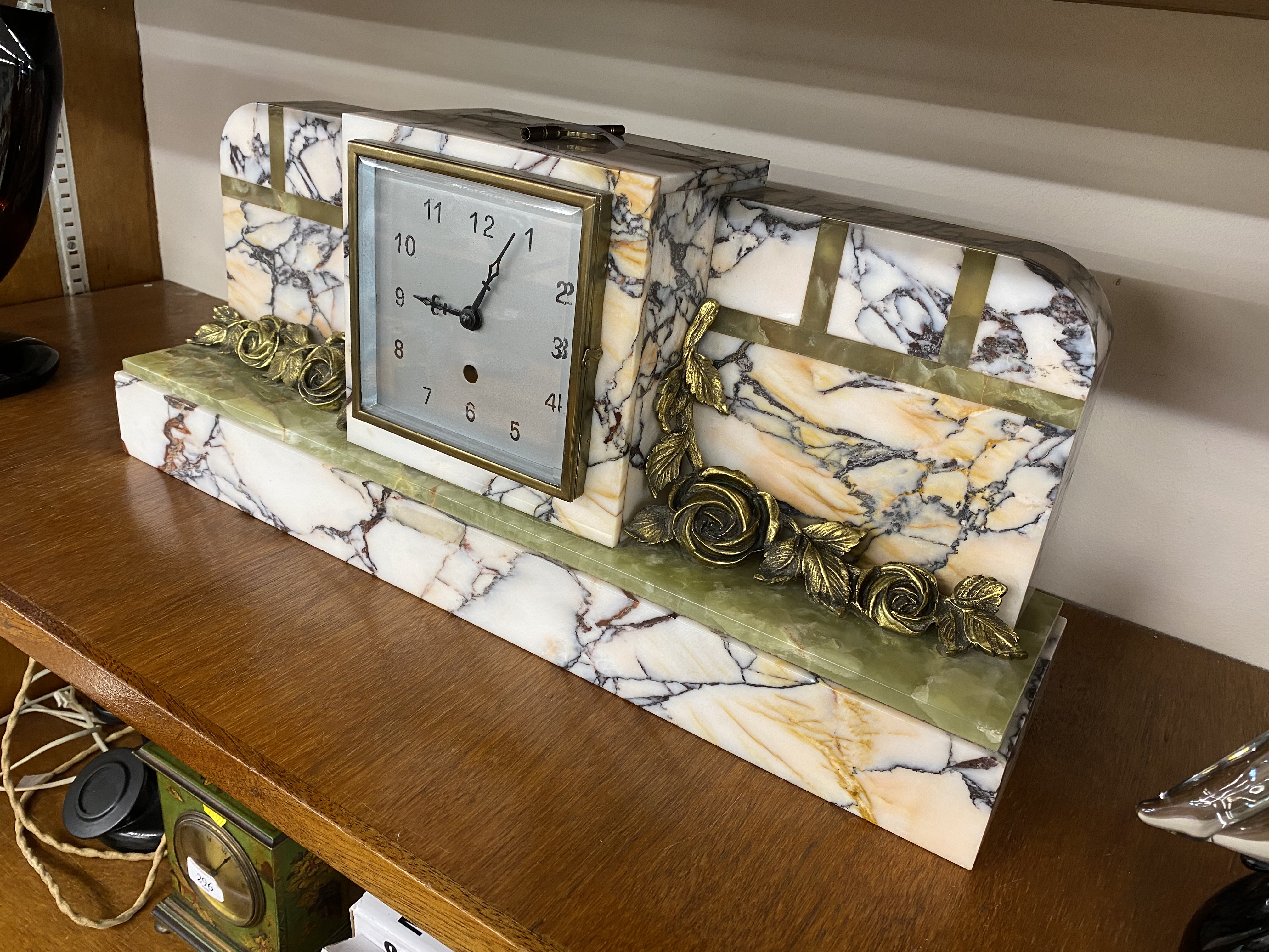 An Art Deco onyx and marble mantel clock, with floral gilt metal applied decoration, 55cm wide 23. - Image 3 of 3