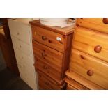 A pair of modern pine bedside chests fitted three