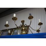 An eight branch brass ceiling light