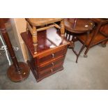 A reproduction three drawer chest