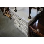 A reproduction three drawer chest