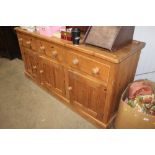 A pine dresser base, fitted three drawers