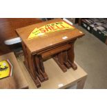 A nest of three oak occasional tables