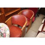 A pair of oak and red leather upholstered chairs