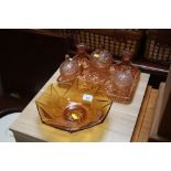 An amber glass bowl; together with a glass dressin