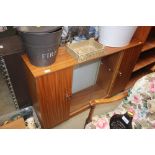 A teak effect glass fronted cabinet