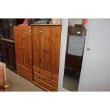 A modern pine wardrobe fitted three drawers below