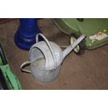 A galvanized watering can