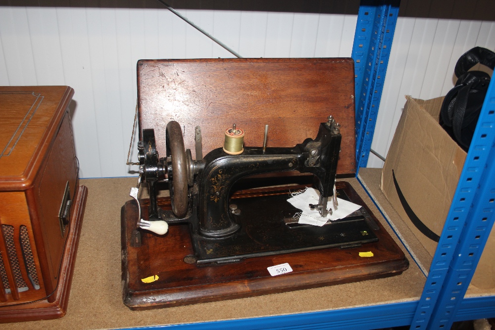 A hand sewing machine in carrying case