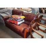 A brown leather upholstered two seater settee