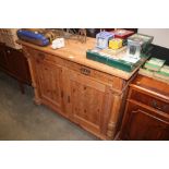 A continental pine cupboard fitted two drawers