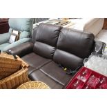 A brown leather upholstered two seater electric re