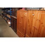 A modern pine wardrobe fitted two drawers below