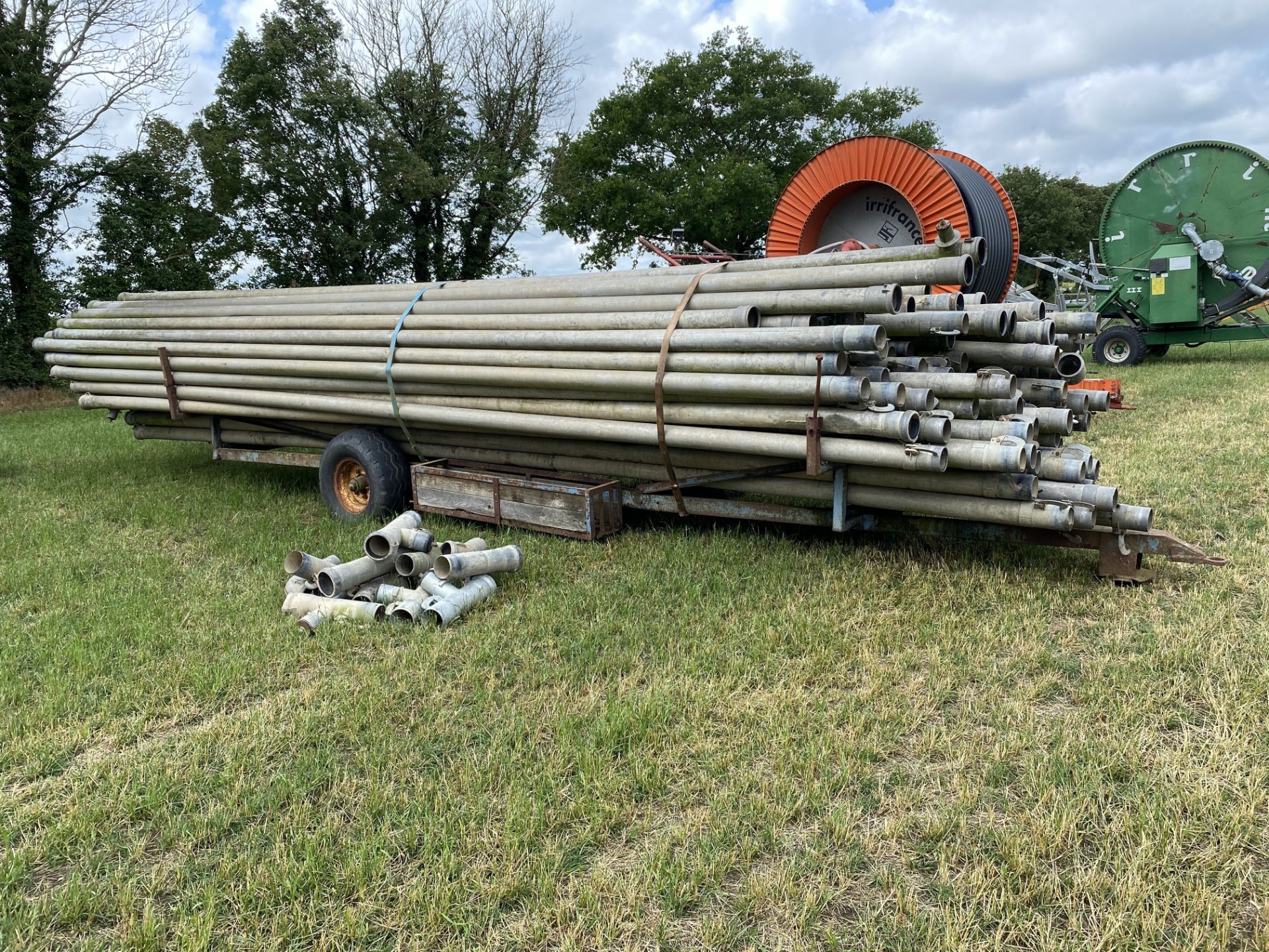 Irrigation pipe trailer and a quantity of pipes. M