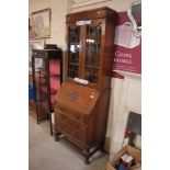 A 1930's oak leaded glazed bureau bookcase