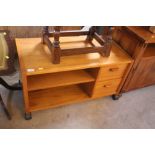 A modern teak tv and stereo unit on wheeled base