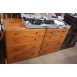A pair of retro walnut four drawer chests