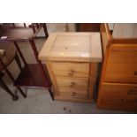 A small pine bedside chest fitted three drawers