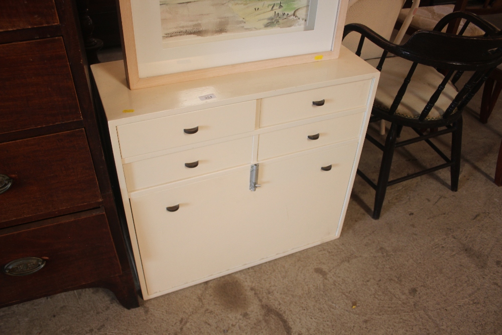 A cream painted side cabinet