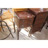 A pair of mahogany bedside chests fitted two short drawers raised on cabriole supports
