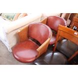 A pair of oak and red leather upholstered tub shap