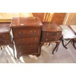 A reproduction mahogany bedside chest having leath