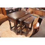 A nest of three good quality oak occasional tables