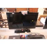 An LG flat screen television with remote control