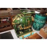 A green glazed pottery elephant jardiniere stand