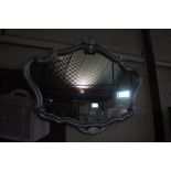 A silvered decorative wall mirror