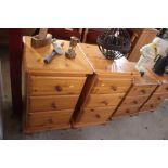 A pair of pine bedside chests fitted three drawers
