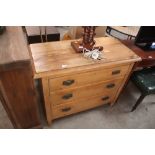 A stripped pine chest of three long drawers