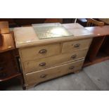 An antique stripped pine chest of two short and tw