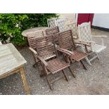 A teak folding garden table; and four folding armc