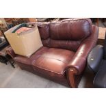 A brown leather upholstered two seater settee