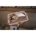 A ladies pink clutch bag and contents of costume j