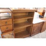 An oak effect open fronted bookcase