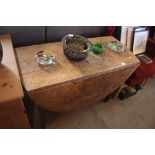 An antique oak drop leaf cottage dining table
