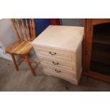 A reproduction three drawer bedside chest